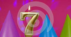 Burning birthday cake candle number 7. Happy Birthday background anniversary celebration concept. Birthday hat in the