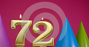 Burning birthday cake candle number 72. Happy Birthday background anniversary celebration concept. Birthday hat in the