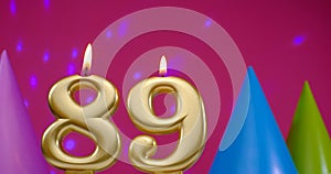 Burning birthday cake candle number 89. Happy Birthday background anniversary celebration concept. Birthday hat in the