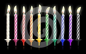 Burning birthday candles isolated on dark background with fire flames. Colorful collection.  Clipping path