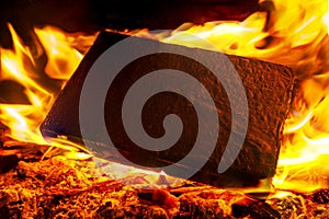 Burning black square board with open red fire flame