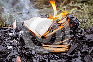 Burning books on the fire, burning books among the ashes photo