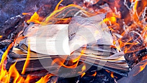 Burning books. An open book on the hearth photo