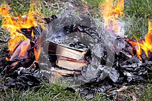 Burning books outdoors, destroying forbidden books, books on the fire photo
