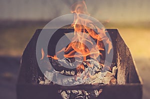 Burning brazier with firewood/burning brazier with firewood, toned