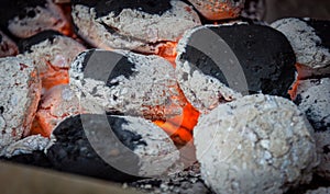 burning briquettes inside the grill