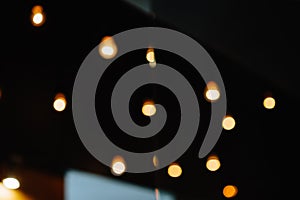 Burning bulb shines weakly on the background