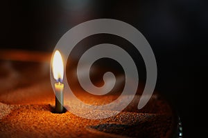 Burning candl in a church on a dark background. Details in the orthodox christian church