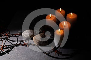 Burning candle, Barbed wire, flag of Israel on dark background. Holocaust memory day