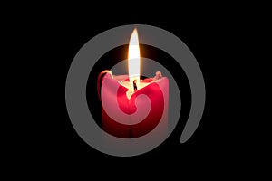 Burning candle on black background