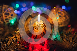 Burning candle and Christmas decoration. Elegant low-key shot with festive mood