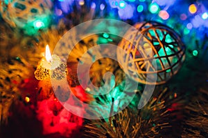 Burning candle and Christmas decoration. Elegant low-key shot with festive mood