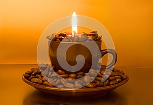 Burning candle and coffee beans