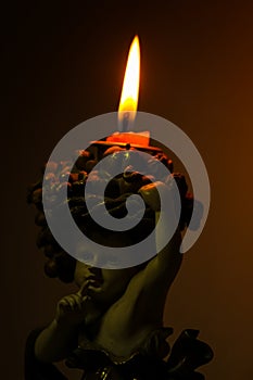 Burning candle in the dark background