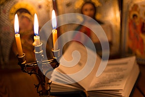 Burning candle in a dark room, orthodox