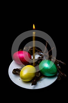 Burning candle and Easter eggs