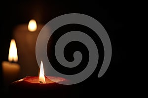 Burning candle flame in the dark