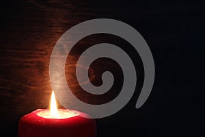 Burning candle flame in the dark