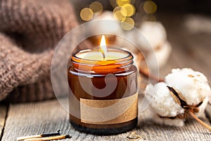 Burning candle in a glass jar with label mock up