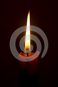 Burning candle isolated on black