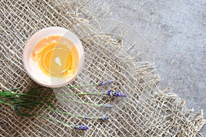 Burning candle and lavender flowers