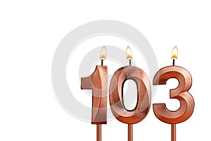 Burning candle number 103 for birthday on white background