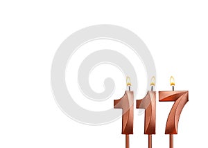 Burning candle number 117 for birthday on white background