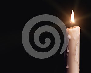 Burning candle over black