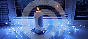 Burning candle over black Background