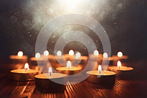 Burning candle over black background