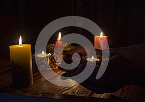 Burning candle on the palms of an elderly woman