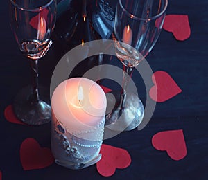 Burning candle, romantic atmosphere. On a wooden board. Valentine`s Day. Valentine