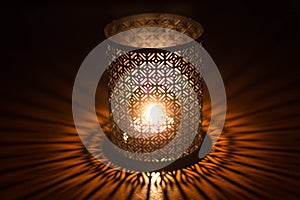 Burning candle in sconce on the table