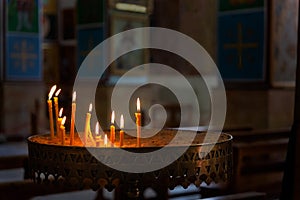 Burning candles in Basilica of Saint George in Madaba, Jordan