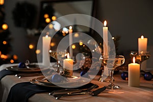 Burning candles on beautiful  table setting for Christmas dinner