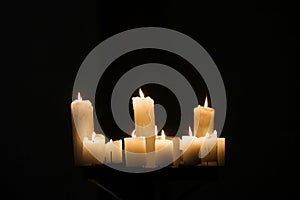 Burning candles on black background