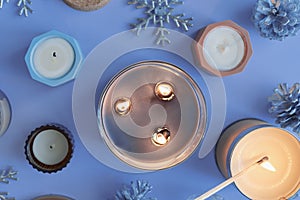 Burning candles on blue background. Winter and Christmas