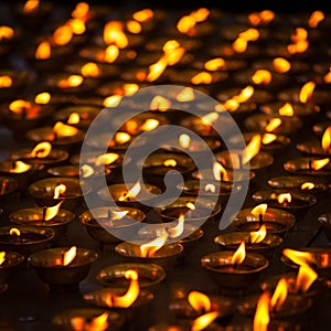 Burning candles in Buddhist temple, India