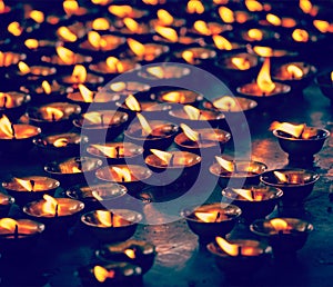 Burning candles in Buddhist temple. McLeod Ganj, Himachal Prades