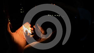 Burning candles in Buddhist temple at night. Men`s hands on fire red large candles in the temple gopro. Red Candle in