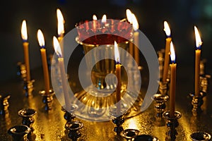 Burning candles on a candlestick in an Orthodox Church