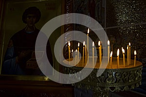 Burning candles in church. Burning candles shining in dark background. Copy space.