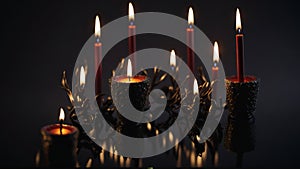 Burning candles on dark background, closeup. Festive decoration