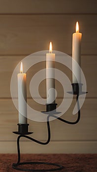 Burning candles glow in candlestick