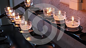 Burning Candles Inside Church Interior, Prayer Candles Lit in Row, Spirituality