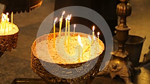 Burning candles inside of orthodox church, paying respects, religious tradition