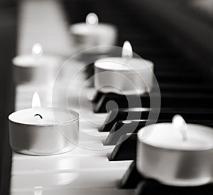 Burning candles and pianoforte photo