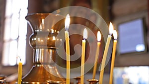 Burning candles. Religious memorial attribute of warmth and sincerity. Close up shot.