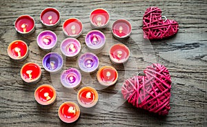 Burning candles with retro cane hearts