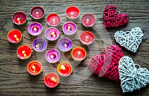 Burning candles with retro cane hearts